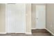 Hallway with wood flooring and a closet, providing access to various parts of the residence at 500 John St St, Clayton, NC 27520