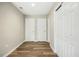 Hallway with wood flooring and white doors, providing access to multiple rooms in the home at 500 John St St, Clayton, NC 27520