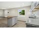 Open-concept living space with kitchen featuring granite counters, stainless appliances, and a wooden island at 500 John St St, Clayton, NC 27520