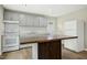 Bright kitchen with stainless appliances, center island, white cabinets and subway tile backsplash at 500 John St St, Clayton, NC 27520