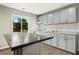 Bright kitchen featuring granite countertops, stainless appliances, island, and a sliding window view at 500 John St St, Clayton, NC 27520