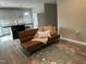 A cozy living room area with light cabinets and updated finishes adjacent to open kitchen at 500 John St St, Clayton, NC 27520