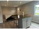 Light and airy living room featuring modern decor, laminate flooring and a kitchen island at 500 John St St, Clayton, NC 27520