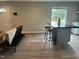 Open-concept living area with vinyl floors, a futon, breakfast bar, and kitchen view at 500 John St St, Clayton, NC 27520