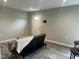 Cozy living room featuring dark futon, neutral colors, and modern laminate flooring at 500 John St St, Clayton, NC 27520