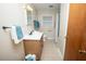 Well-lit bathroom featuring a single vanity, wood-look cabinet, and a shower with a shower curtain at 505 E Graham St, Mebane, NC 27302