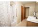 Bathroom featuring a bathtub with shower, a single sink vanity, and bright lighting at 505 E Graham St, Mebane, NC 27302