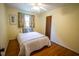 Comfortable bedroom with hardwood floors, a window, and a ceiling fan, offering a bright and inviting space at 505 E Graham St, Mebane, NC 27302