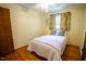 Cozy bedroom with hardwood floors, neutral walls, a ceiling fan, and a bright window at 505 E Graham St, Mebane, NC 27302