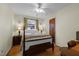 Inviting bedroom features hardwood floors, ceiling fan, and a cozy bed with a quilt at 505 E Graham St, Mebane, NC 27302