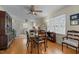 Cozy dining area with hardwood floors, ceiling fan, and bright natural light from large window at 505 E Graham St, Mebane, NC 27302
