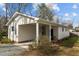 Back of a home featuring covered parking and mature landscaping at 505 E Graham St, Mebane, NC 27302