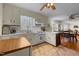 The kitchen opens to the breakfast nook, featuring white cabinetry and neutral flooring at 505 E Graham St, Mebane, NC 27302