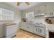 Functional kitchen with white cabinetry, laminate countertops and neutral flooring at 505 E Graham St, Mebane, NC 27302