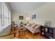 Cozy living room with natural light, hardwood floors, and a comfortable seating area at 505 E Graham St, Mebane, NC 27302