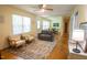 Spacious living area with hardwood floors, bright windows, and comfortable seating; the room opens to an adjacent dining area at 505 E Graham St, Mebane, NC 27302