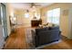 Open-concept living room features hardwood floors, neutral paint, and comfortable seating, flowing into the adjacent kitchen at 505 E Graham St, Mebane, NC 27302