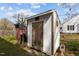 An exterior view of a wooden storage shed with a simple door and latch at 505 E Graham St, Mebane, NC 27302