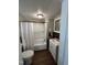 Bathroom featuring a shower-tub combo, vanity, and wood-look flooring at 5116 Nc 56 Hwy, Franklinton, NC 27525