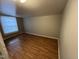 Bedroom featuring wood-look flooring and a large window at 5116 Nc 56 Hwy, Franklinton, NC 27525