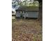 The house has gray siding and a small front porch with some greenery and a tree at 5116 Nc 56 Hwy, Franklinton, NC 27525