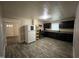Kitchen area with modern cabinetry, appliances, and wood-look flooring at 5116 Nc 56 Hwy, Franklinton, NC 27525