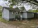 Rear exterior shot of a one-story house with a gravel driveway and fenced yard at 5116 Nc 56 Hwy, Franklinton, NC 27525