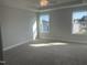 Bright and airy bedroom with two large windows, neutral carpet, and a modern ceiling fan at 540 Eversden Dr, Zebulon, NC 27597