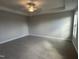 Spacious bedroom with neutral carpet, a modern ceiling fan, and plenty of natural light at 540 Eversden Dr, Zebulon, NC 27597
