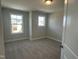 Bedroom featuring two windows, neutral carpet, and fresh, neutral paint at 540 Eversden Dr, Zebulon, NC 27597