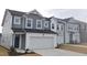 Stylish two-story townhome with a two-car garage, modern exterior, and well-maintained landscaping at 540 Eversden Dr, Zebulon, NC 27597