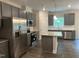 Modern kitchen featuring stainless steel appliances, gray cabinets, granite countertops, and a central island at 540 Eversden Dr, Zebulon, NC 27597