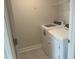 Functional laundry room with modern washer and dryer units, plus wire shelving for added storage at 540 Eversden Dr, Zebulon, NC 27597