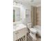 Bathroom featuring a bath, vanity, decorative mirror and neutral color palette at 5507 Vista View Ct, Raleigh, NC 27612