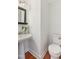 Half bathroom features a stylish pedestal sink and modern toilet for a clean and functional space at 5507 Vista View Ct, Raleigh, NC 27612
