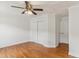 Bright bedroom featuring hardwood floors, white trim, and ceiling fan with light at 5507 Vista View Ct, Raleigh, NC 27612
