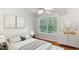 Well-lit bedroom with bed, side table, decor, and large window with natural views at 5507 Vista View Ct, Raleigh, NC 27612