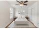 Digitally staged bedroom with hardwood floor, ceiling fan, window, and closet at 5507 Vista View Ct, Raleigh, NC 27612