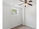 Bedroom with neutral walls, ceiling fan, plush carpeting, and a bright window at 5507 Vista View Ct, Raleigh, NC 27612