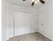 Bedroom featuring neutral carpet, closet, ceiling fan with light, and an entry door at 5507 Vista View Ct, Raleigh, NC 27612
