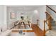Bright dining room boasts hardwood floors, wainscoting, and a modern light fixture over the dining table at 5507 Vista View Ct, Raleigh, NC 27612