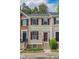 Charming townhouse featuring light siding, dark shutters, and a well-manicured front garden at 5507 Vista View Ct, Raleigh, NC 27612