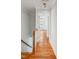 Hallway leading to a bedroom with hardwood floors and white trim at 5507 Vista View Ct, Raleigh, NC 27612