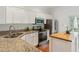 This kitchen features stainless appliances, granite countertops, and white cabinets for a sleek, modern look at 5507 Vista View Ct, Raleigh, NC 27612