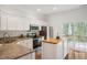 This kitchen boasts stainless appliances, granite countertops, and a butcher block island with a deck view at 5507 Vista View Ct, Raleigh, NC 27612