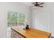 The kitchen island offers additional counter space and storage with an adjacent deck view and ceiling fan at 5507 Vista View Ct, Raleigh, NC 27612