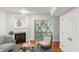 A cozy living room features a fireplace, access to outdoor space, hardwood floors, and a comfortable sitting area at 5507 Vista View Ct, Raleigh, NC 27612