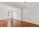 This living room is bright with hardwood floors, recessed lights, and white walls and decorative molding at 5507 Vista View Ct, Raleigh, NC 27612