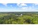 Expansive aerial view of a lush, green landscape featuring a serene lake surrounded by dense trees at 5541 Old Still Rd, Wake Forest, NC 27587