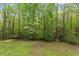 Picturesque backyard featuring mature trees and lush greenery create a private retreat at 5541 Old Still Rd, Wake Forest, NC 27587